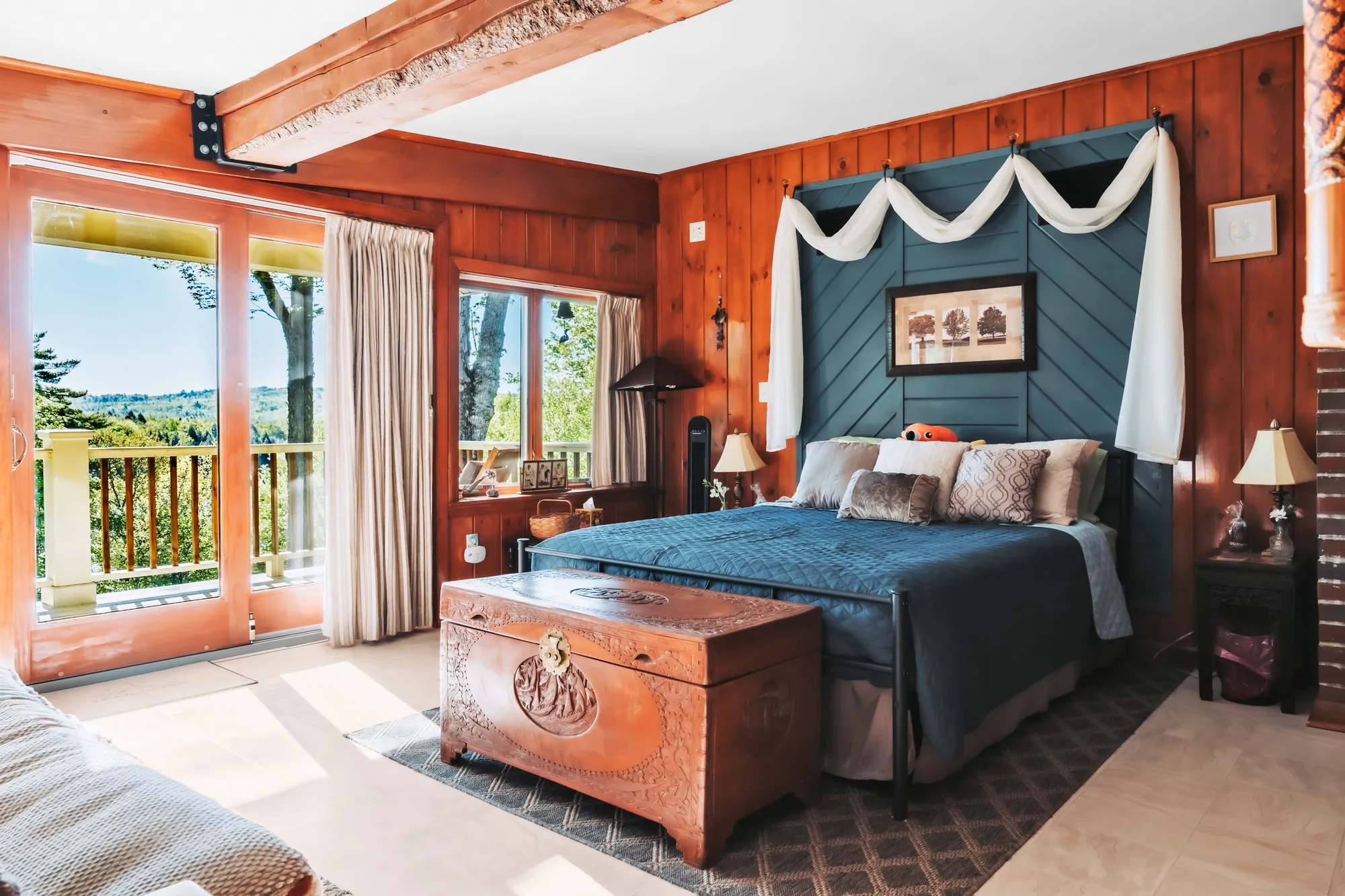 Main House bedroom opening toward its private balcony