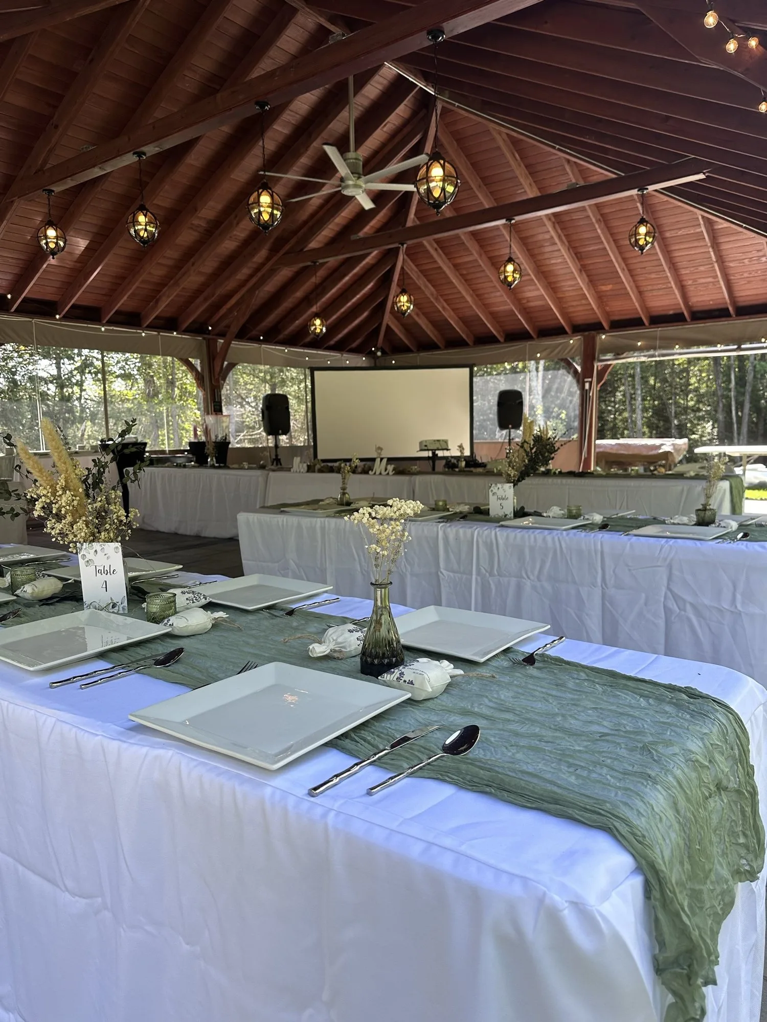 Reception tables prepared beneath Thunder Hall at Dragonwood