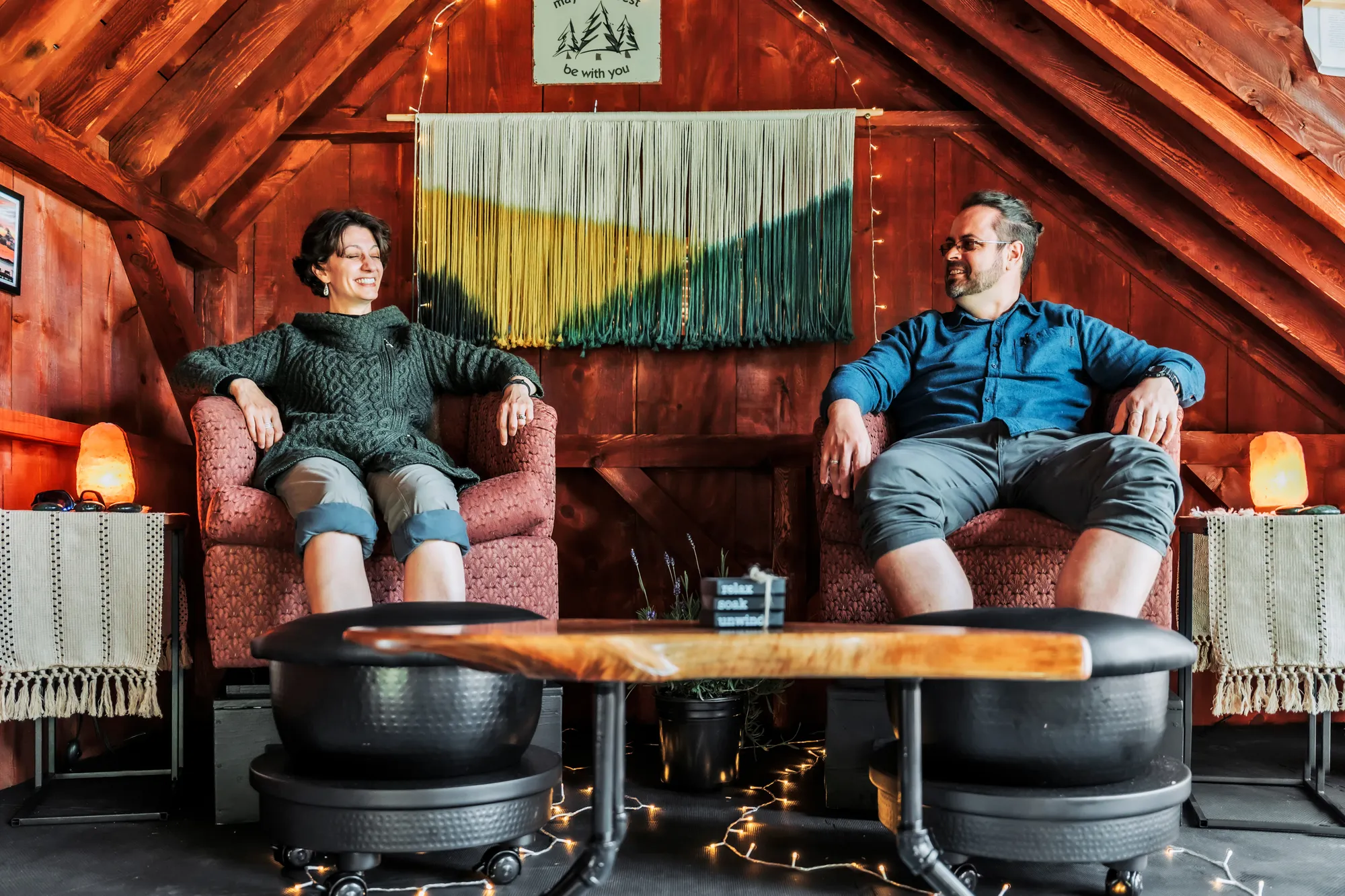 Guests enjoying herbal foot soaks inside The Gallery at Dragonwood