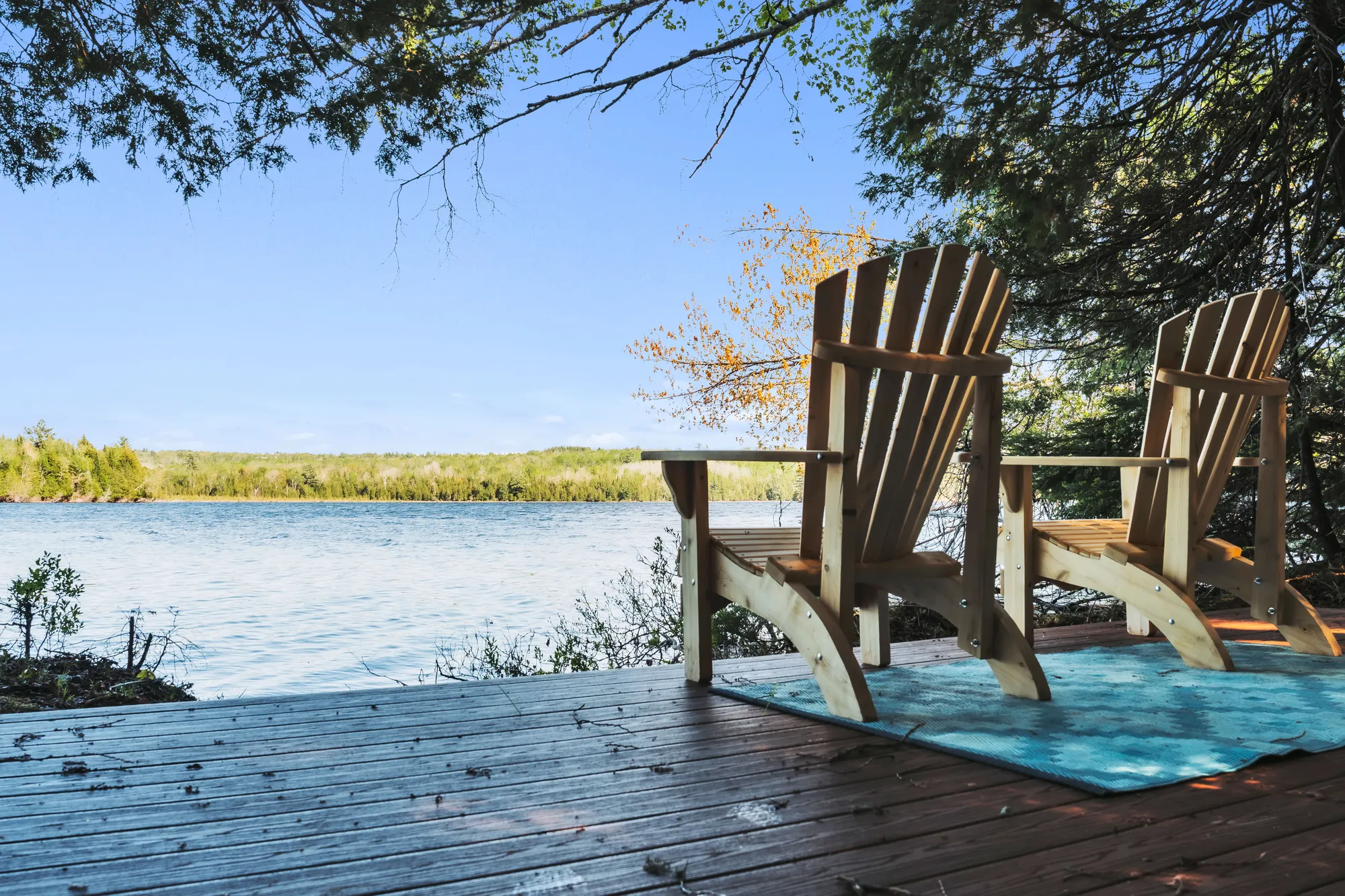 Two chairs at a quiet waterfront deck