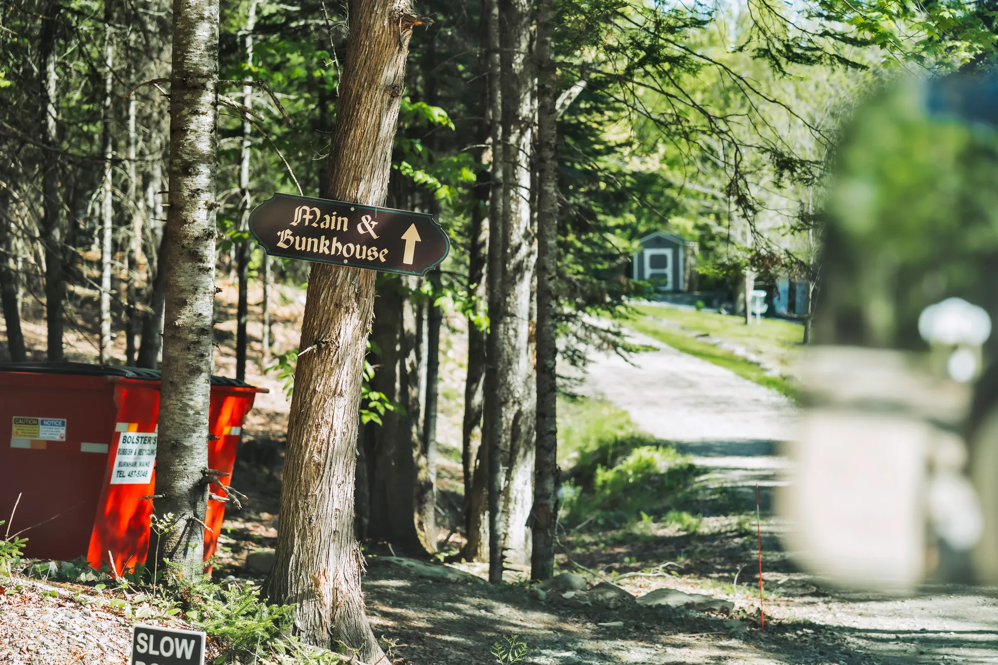 Woodland sign pointing toward the Main House and Bunk House