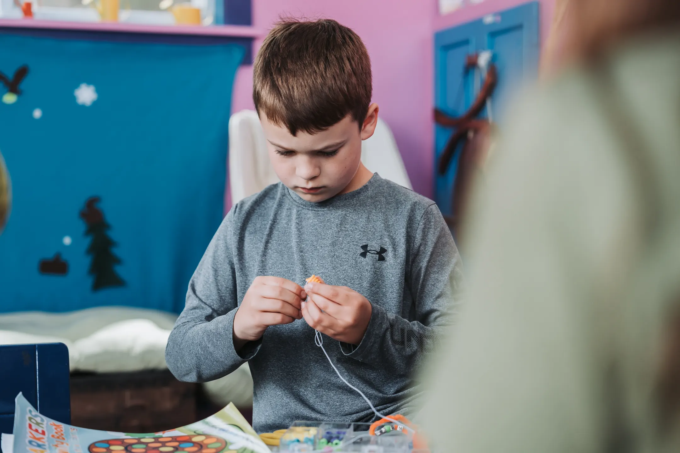 A child creating a colorful project in the Design Studio