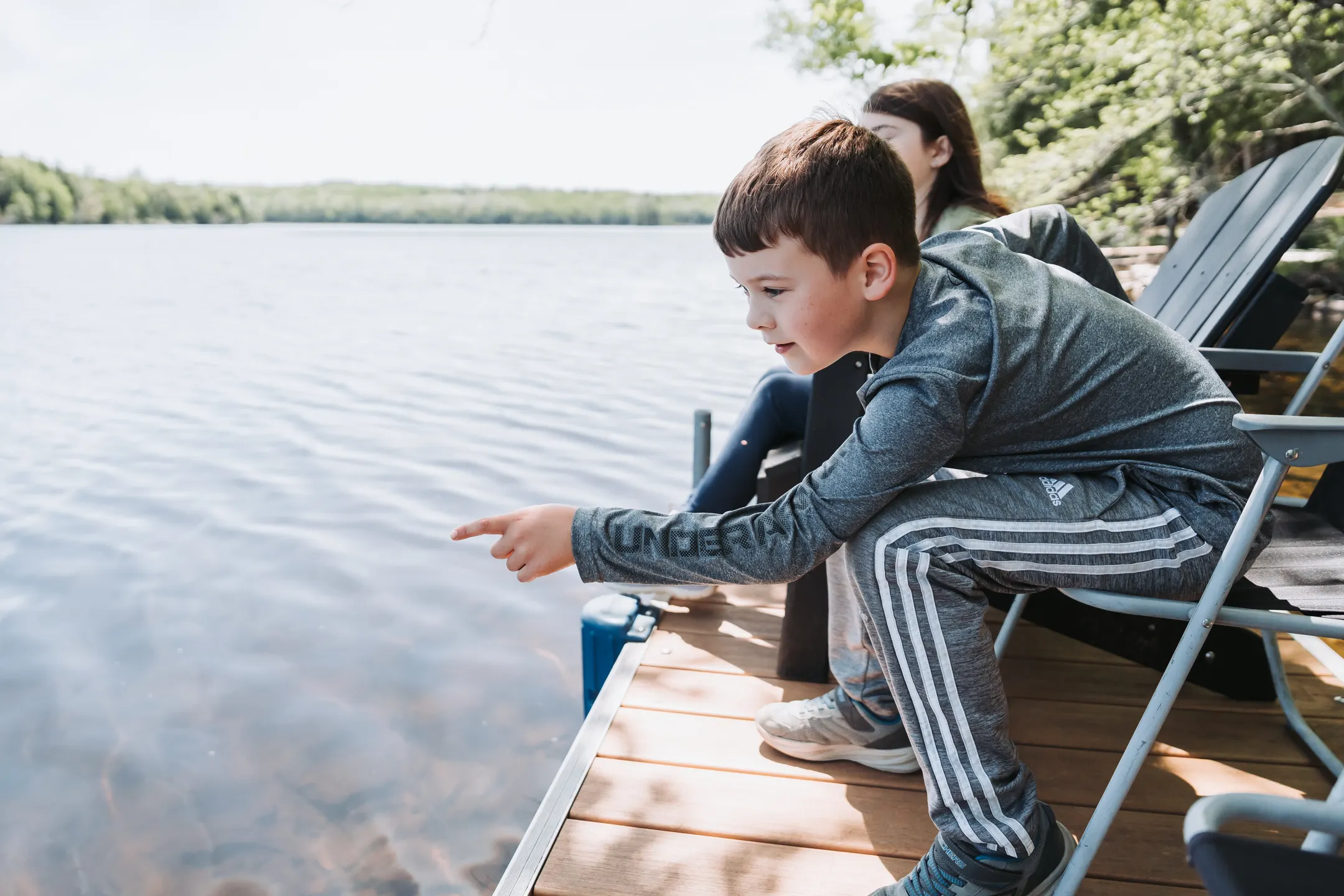 A child fishing from the dock at Dragonwood